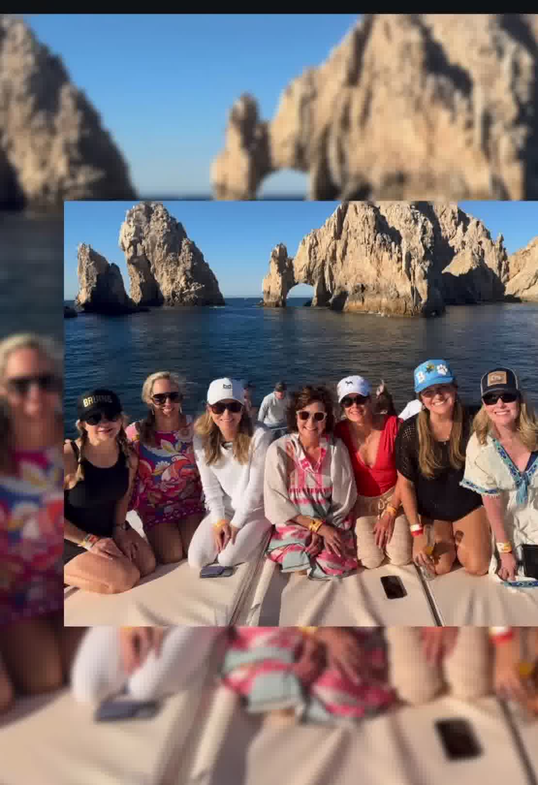 Women smiling on a yacht with Cabo Arch behind