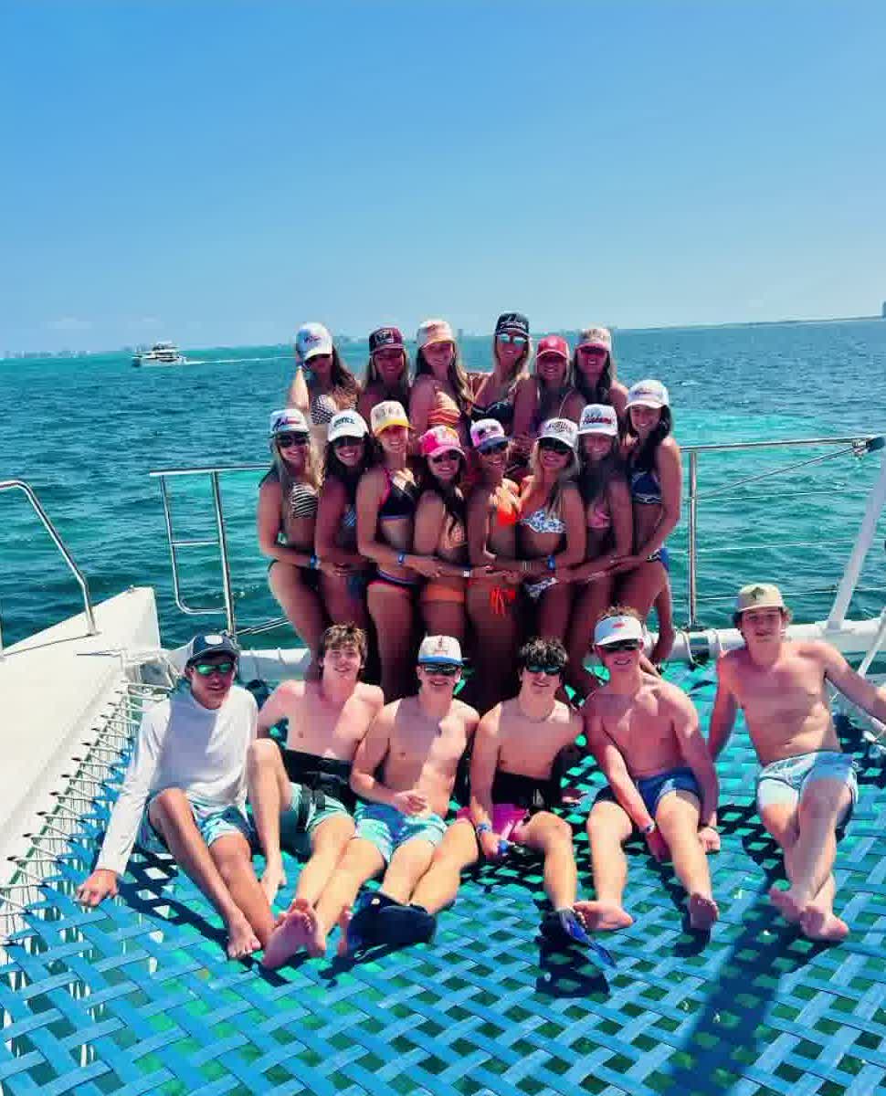 Senior trip group on a catamaran in clear blue water
